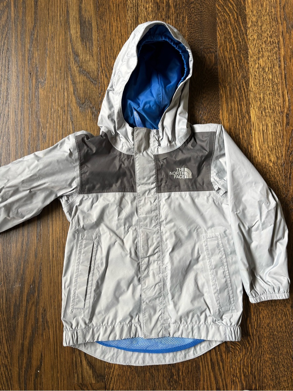 The North Face Kids' Light Gray and Dark Gray Rain Jacket with Blue Lining